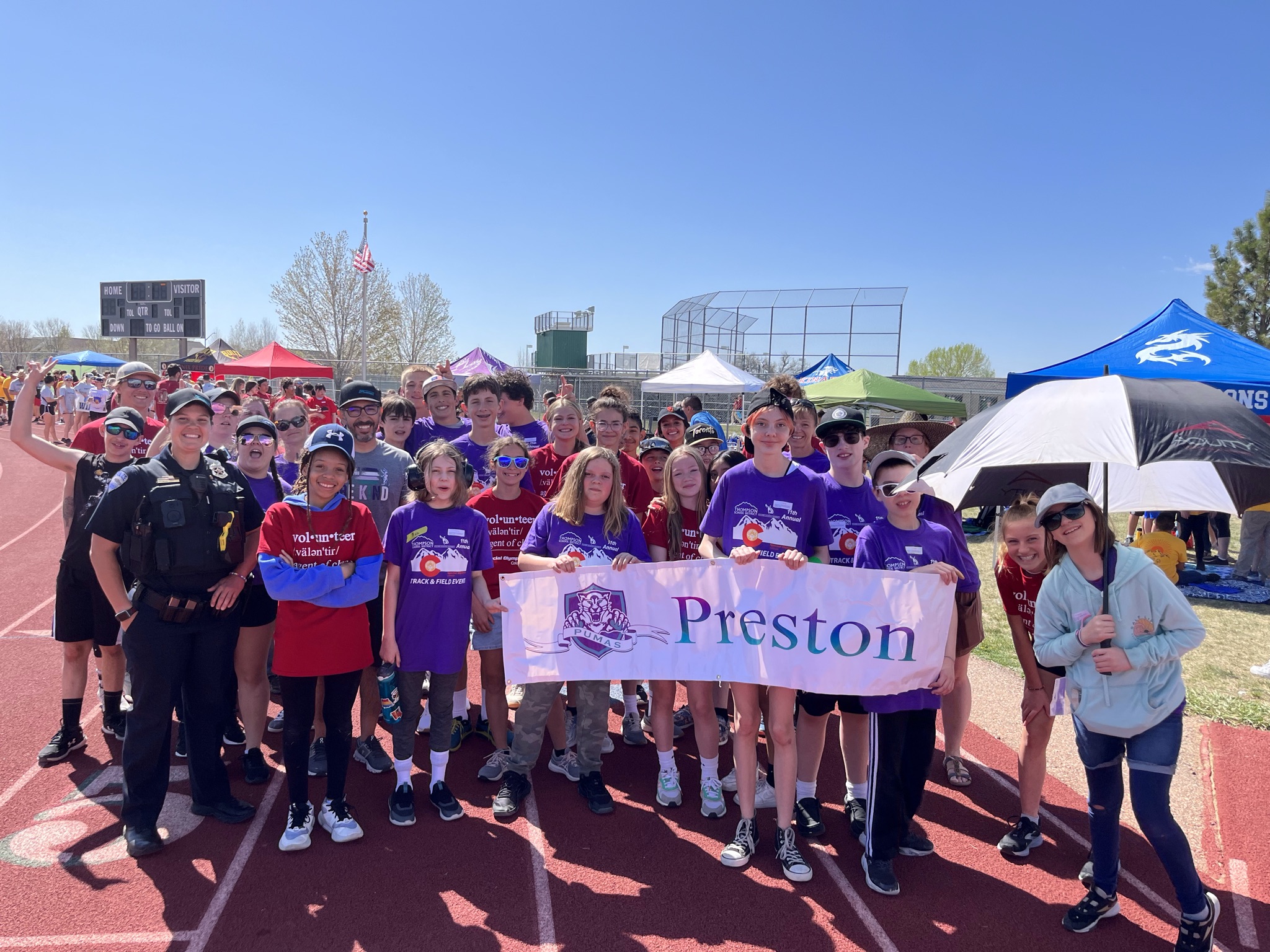students from 2022-2023  holding preston sign at the starting line of the special olympics