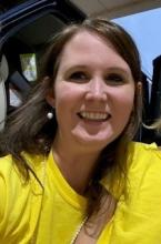 Mrs. Wilson is smiling.